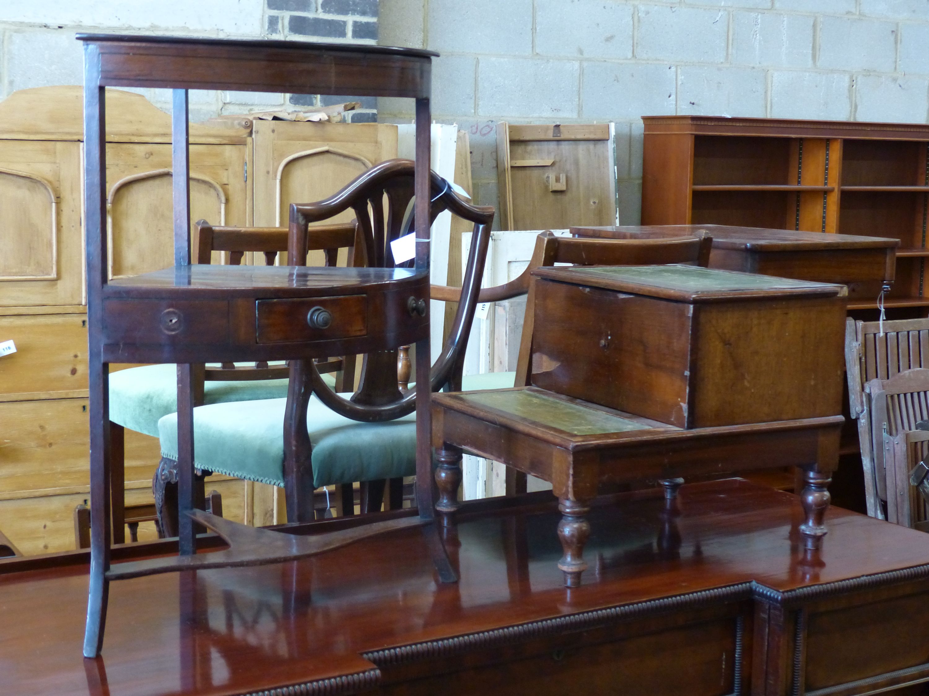 A George III mahogany bow fronted corner washstand, height 80cm together with a Victorian mahogany step commode (converted) (2)